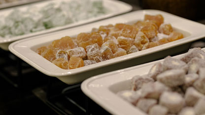 Close-up of trays filled with assorted powdered candies or jellies in different colors and flavors.